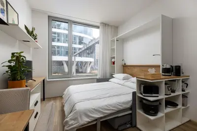 a bedroom with a bed and a large window at Modern Apartment Near Anděl & Metro in Prague