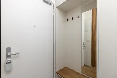 a bathroom with a glass door and a mirror at Modern Apartment Near Anděl & Metro in Prague