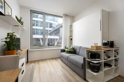 a living room with a couch and a window at Modern Apartment Near Anděl & Metro in Prague