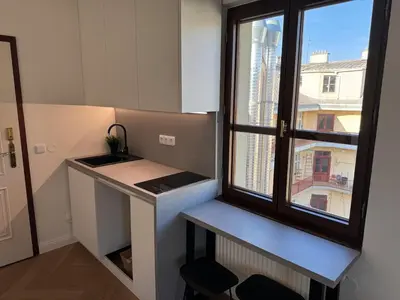 a small kitchen with a sink and a window at Modern apartment near Wenceslas square in Prague