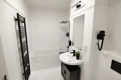 a white bathroom with a sink and a shower at Modern apartment near Wenceslas square in Prague
