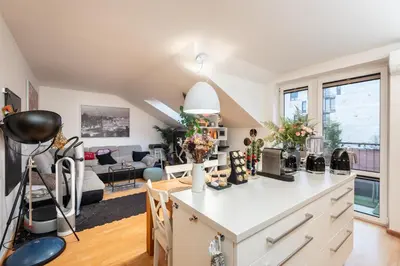 a kitchen and living room with a counter top at QUIET apartment with FREE parking & balcony in Prague