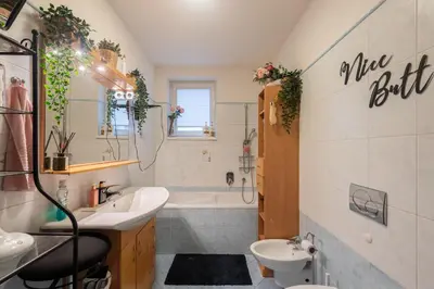a bathroom with a sink and a tub and a toilet at QUIET apartment with FREE parking & balcony in Prague