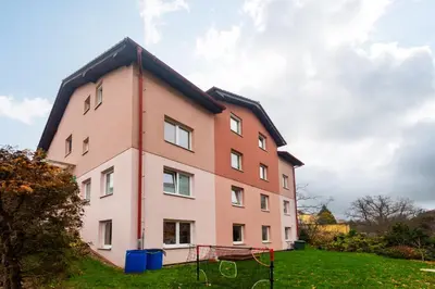 a building with a playground in front of it at QUIET apartment with FREE parking & balcony in Prague