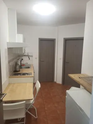 a kitchen with a table and a stove top oven at Komárov Apartment 3 in Komárov