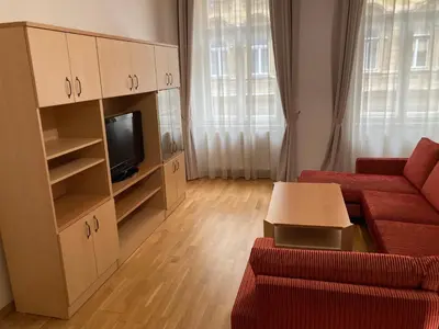 a living room with a red couch and a tv at Apartment with two bedrooms in Prague