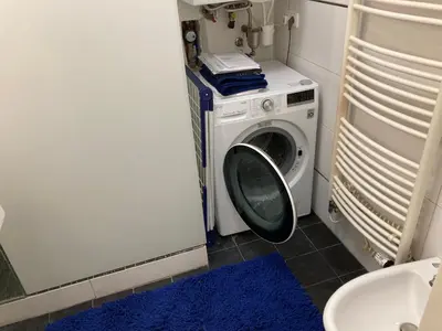 a washer and dryer in a bathroom with a washing machine at Apartment with two bedrooms in Prague