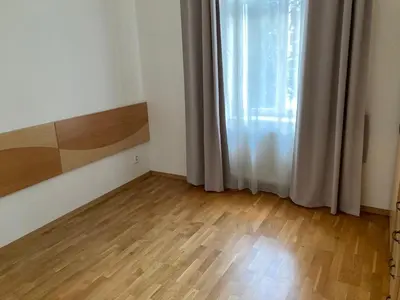 an empty room with a wooden floor and a window at Apartment with two bedrooms in Prague
