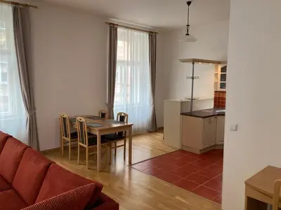 a living room with a table and a kitchen at Apartment with two bedrooms in Prague