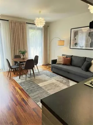 a living room with a couch and a table at Fortuna Garden IV in Prague