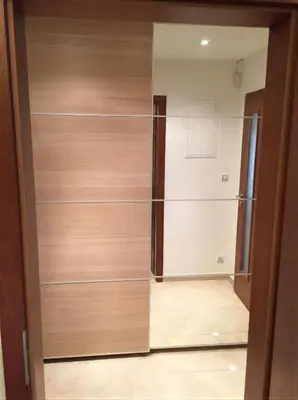 a closet with wooden doors in a room at Fortuna Garden IV in Prague