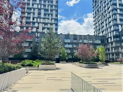 a courtyard in front of a building with tall buildings at Fortuna Garden IV in Prague