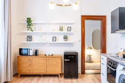 a kitchen with a refrigerator and a wooden cabinet at Prague Days - Apartments with Parking in New Town in Prague
