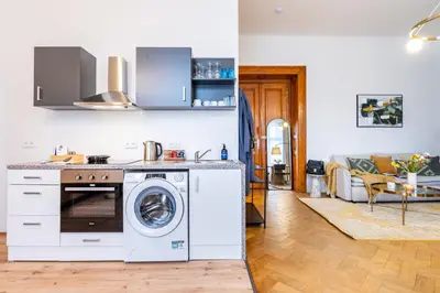 a kitchen and living room with a washer and dryer at Prague Days - Apartments with Parking in New Town in Prague