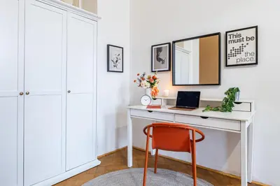 a desk with a laptop and a mirror at Prague Days - Apartments with Parking in New Town in Prague