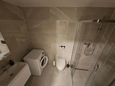 a bathroom with a toilet and a shower at Centre NEW modern apartment & parking near O2 arena in Prague