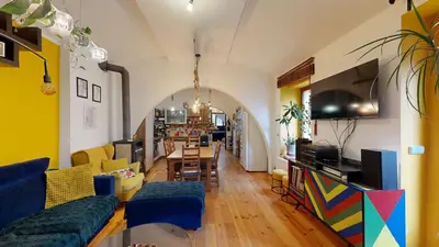a living room with a blue couch and a table at La Casa Colorata apartment in the hearth of Prague in Prague