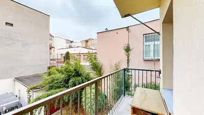 an apartment balcony with a view of a street at La Casa Colorata apartment in the hearth of Prague in Prague