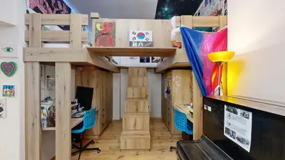 a bedroom with a bunk bed and a desk at La Casa Colorata apartment in the hearth of Prague in Prague
