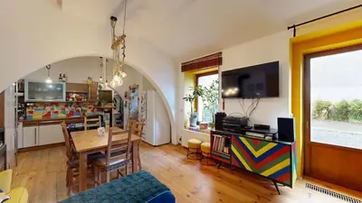 a living room with a table and a dining room at La Casa Colorata apartment in the hearth of Prague in Prague