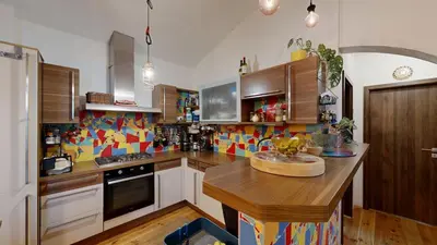 a kitchen with a wooden counter top in a room at La Casa Colorata apartment in the hearth of Prague in Prague