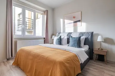 a bedroom with a large bed with blue pillows at Blueground Vršovice view nr Vyšehrad PRG-84 in Prague