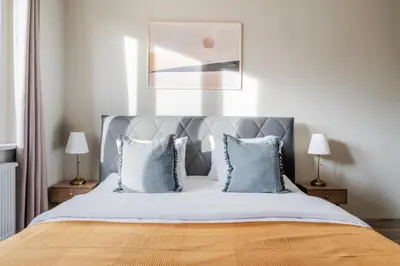 a bedroom with a large bed with blue pillows at Blueground Vršovice view nr Vyšehrad PRG-84 in Prague