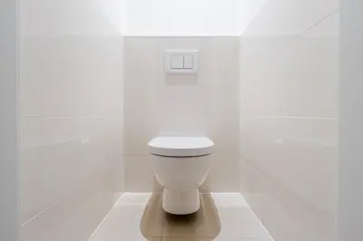 a white bathroom with a toilet in the corner at Blueground Vršovice view nr Vyšehrad PRG-84 in Prague