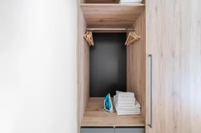 a room with a closet with towels on a shelf at Blueground Vršovice view nr Vyšehrad PRG-84 in Prague