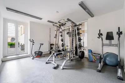 a gym with several exercise equipment in a room at Blueground Vršovice view nr Vyšehrad PRG-84 in Prague