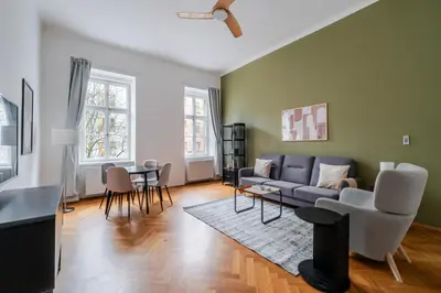 a living room with a couch and a table at Blueground Malá Strana view nr Prague Castle PRG-94 in Prague