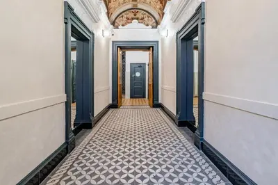 an empty hallway with a door and a tile floor at Blueground Malá Strana view nr Prague Castle PRG-94 in Prague
