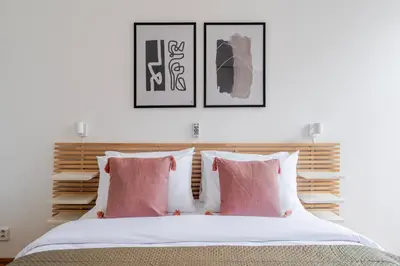 a bedroom with a bed with pink and white pillows at Blueground Malá Strana view nr Prague Castle PRG-94 in Prague