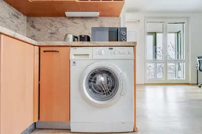 a white washer and dryer in a kitchen at Blueground Vinohrady pool nr Vyšehrad PRG-88 in Prague