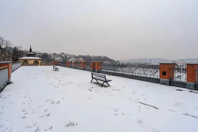 a bench on a bridge covered in snow at Blueground Vinohrady pool nr Vyšehrad PRG-88 in Prague