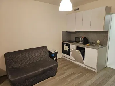 a small kitchen with a couch and a microwave at Centre NEW stylish apartment & parking near O2 Arena in Prague