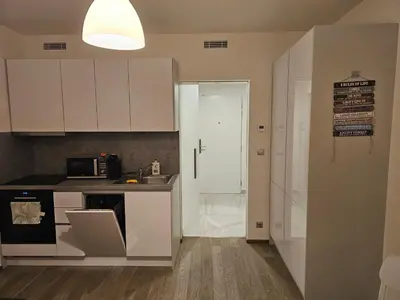 a kitchen with white cabinets and a counter top at Centre NEW stylish apartment & parking near O2 Arena in Prague