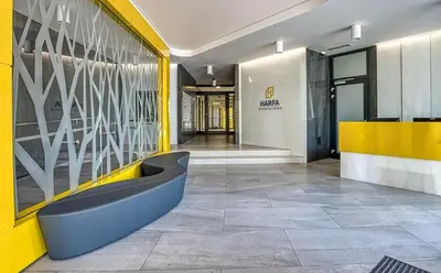 a lobby of a building with a yellow and white wall at Centre NEW stylish apartment & parking near O2 Arena in Prague