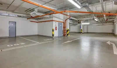 an empty parking garage with yellow and white markings on the floor at Centre NEW stylish apartment & parking near O2 Arena in Prague