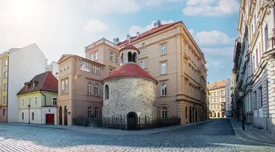 a large building with a tower on a street at read host profile # 5BR SOHO Suites Old Town PS5 Billiards B205 in Prague