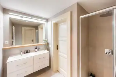 a bathroom with a sink and a mirror at read host profile # 5BR SOHO Suites Old Town PS5 Billiards B205 in Prague