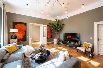 a living room with a couch and a table at read host profile # 5BR SOHO Suites Old Town PS5 Billiards B205 in Prague