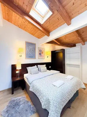 a bedroom with two beds and a skylight at Maisonette General Stefanik in Prague
