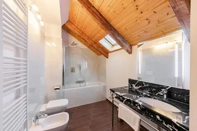 a bathroom with a sink and a toilet and a tub at Maisonette General Stefanik in Prague
