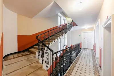 a staircase in a home with a black and white stair treadnsicsnsicsnsicsintendent at Maisonette General Stefanik in Prague
