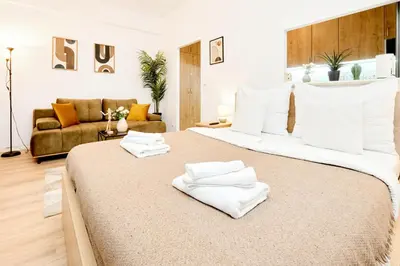 a bedroom with a large bed with white towels on it at Casa Center Apartments in Prague
