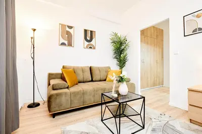 a living room with a couch and a table at Casa Center Apartments in Prague