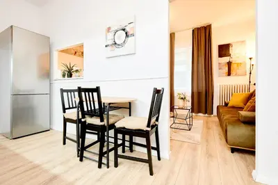 a kitchen and living room with a table and chairs at Casa Center Apartments in Prague