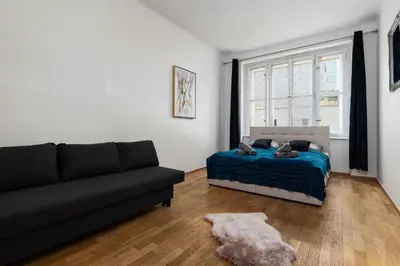 a living room with a couch and a bed at Golden Aurora Prague in Prague