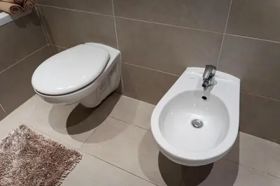 a bathroom with a toilet and a bidet at Golden Aurora Prague in Prague